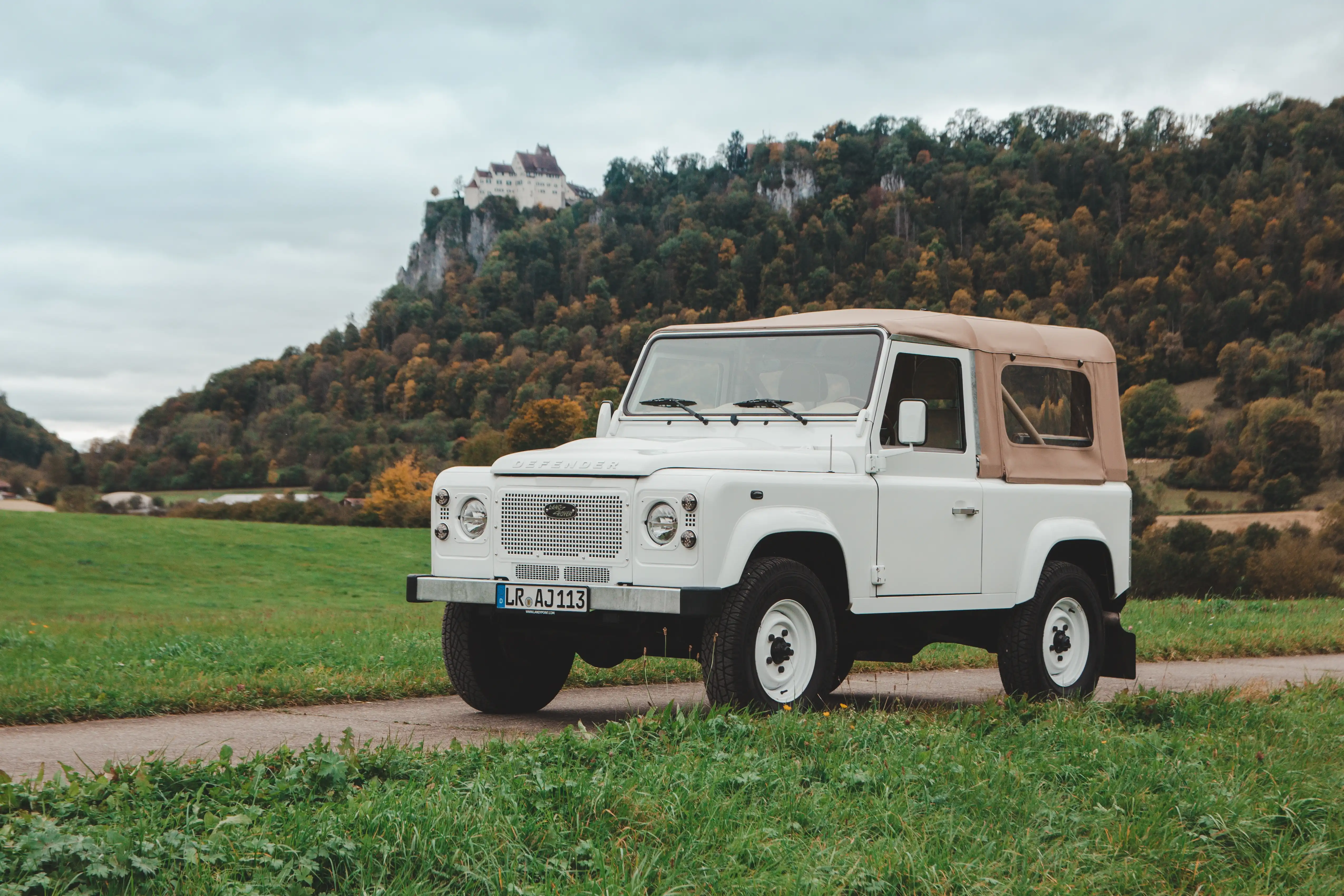 Land Rover mit hellem Verdeck in der Landschaft